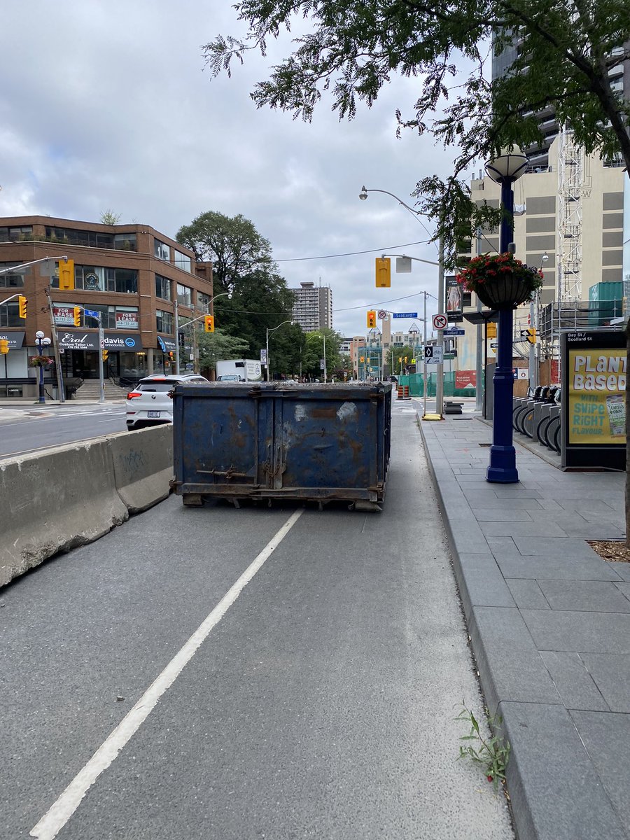 A *very* narrow excuse for a bike lane on Bay St. just north of Bloor this morning where a garbage bin sat empty. <a href="/311Toronto/">311 Toronto</a> what’s the plan here pls?