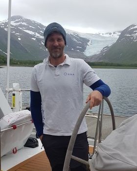 Anasailing's tweet photo. Our former student Igor Sundic went to Norway in June. The photo in ANA t-shirt was taken near glacier Svartisen (Norway) inside the Arctic circle... Is it the northernmost point among ANA's students reached by sails? 
#anasail #sailing #artcticsailing #proudofourstudents https://t.co/yaJ3UNCwra