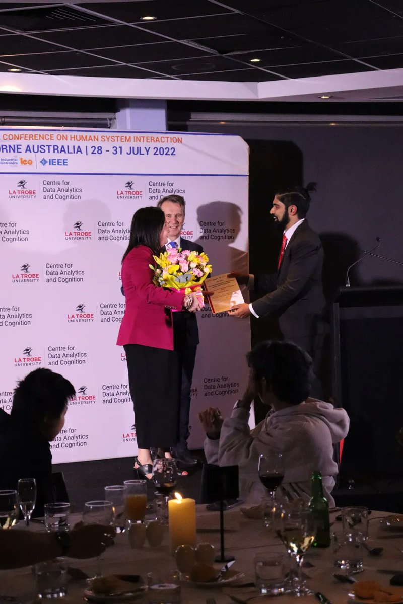 hsiconf's tweet photo. General chairs Prof. @dswnds, Prof. Jacek Rumiński, presenting Belinda Westerlo with a special award that recognises her dedication and commitment towards HSI 2022, in Conference Strategy, Corporate Sponsorship, Conference Finances, Stakeholder Engagement, Digital Marketing. https://t.co/lr5oEE0Psu