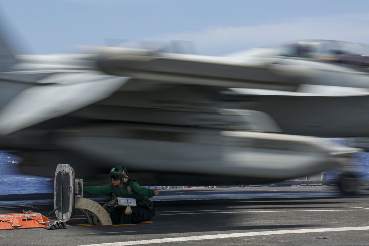 Life near the fast lane.  
A <a href="/USNavy/">U.S. Navy</a> sailor directs the launch of an EA-18G Growler on the flight deck of USS Abraham Lincoln, which is operating in the Pacific Ocean.