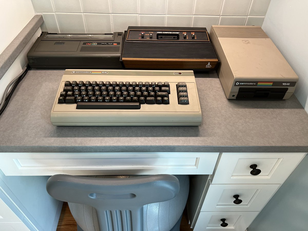 Chris_Kez's tweet photo. @Thurrottfeed @thurrott In a funny coincidence, I was unpacking over the weekend and found my old C64. (Also pictured, accompanying disk drive, Okimate 10 printer, Atari 2600). https://t.co/MrD0jwK2af