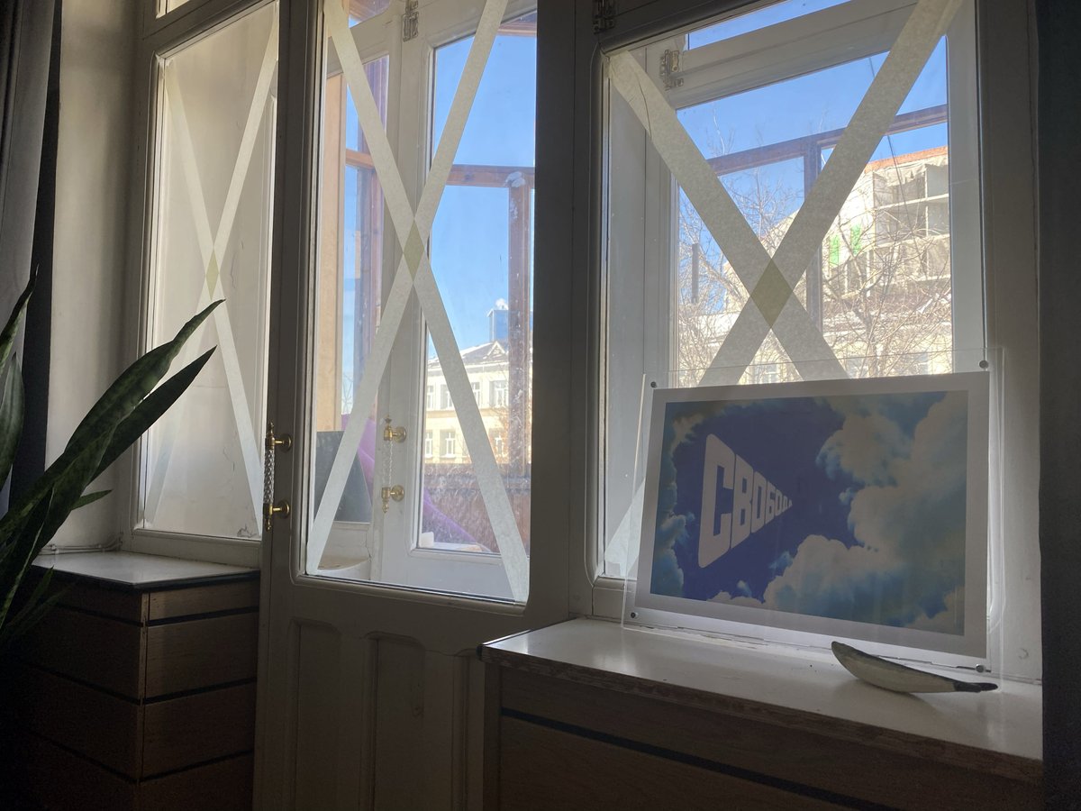 | 322 | Day 134 - 9:01 PM |
Copy of Eric Bulatov's famous painting "Freedom", created for the Boris Yeltsin Museum in 2015, next to the windows cross-taped with paper duct tape  
 ------
War is still there.  ̶S̶t̶a̶n̶d̶ ̶ stay with Ukraine
