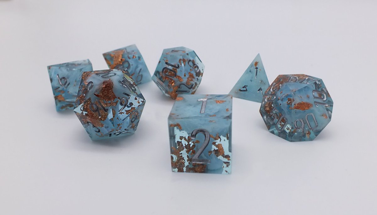 A nice group shot of my artificer inspired set⚡️ They also have a subtle glow in the dark effect after they've been exposed to UV🌟

#dice #handmadedice #ttrpg #DnD #diceset