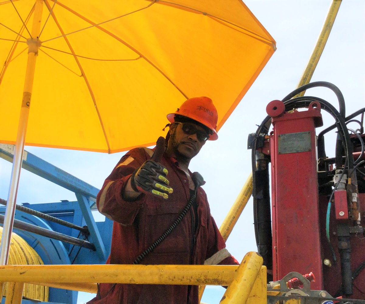 Helix_ESG's tweet photo. Willie Neal, a Floorhand on the Helix #Q4000, is doing his best to stay out of the direct sunlight by standing under an extra-large umbrella while operating the tugger on the rig floor. #HelixESG #HLX #Safety #StayCool #OffshoreLife https://t.co/6YRP5Mb2Vd