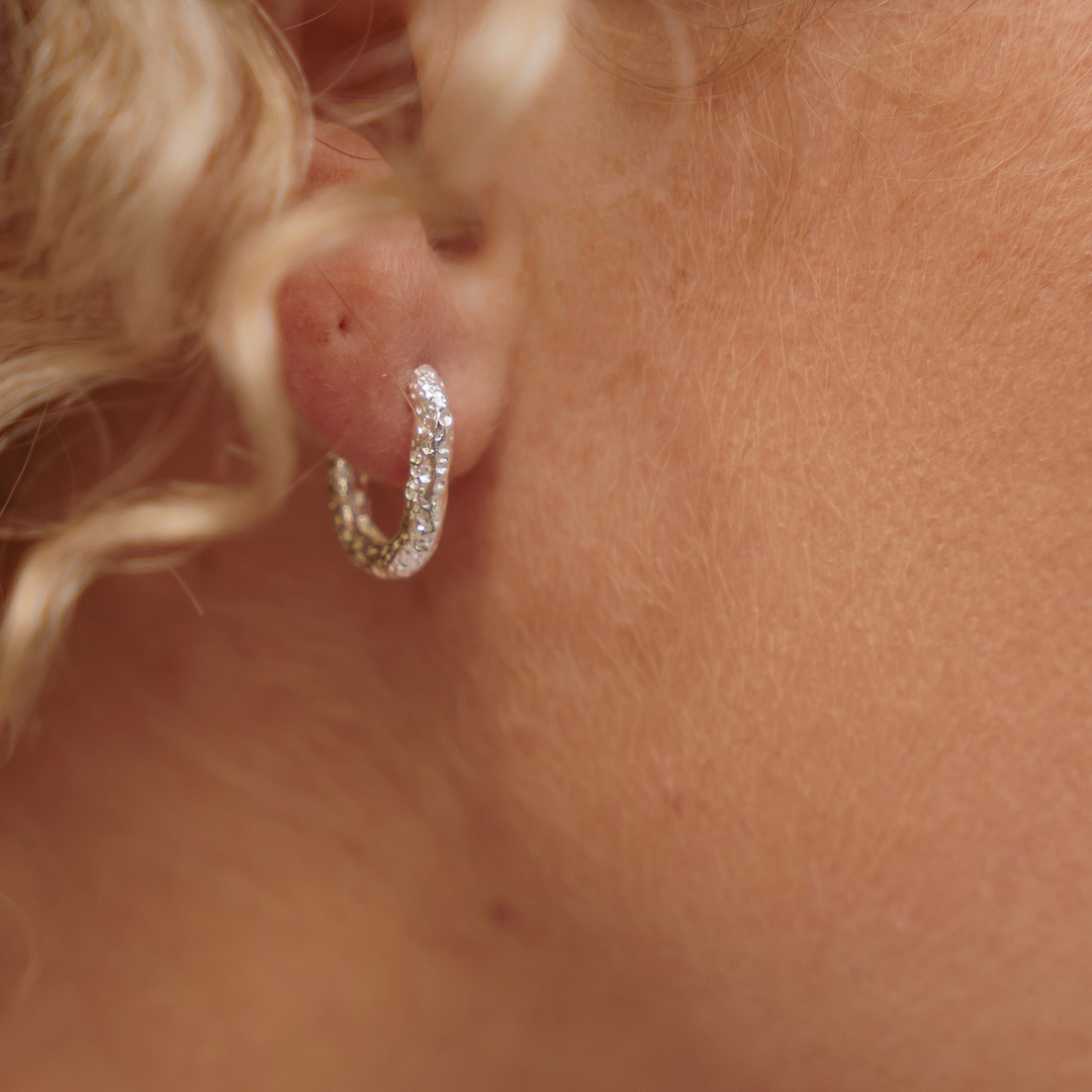 The Rockpool Hoops 

Lost to the sea for centuries, these dainty silver Rockpool hoops organically evolved - shaped by the relentless tide, engrained by the sandy seabed and sculpted by the ocean waves 🌊 

These intricate and eye-catching earrings have been created in solid st