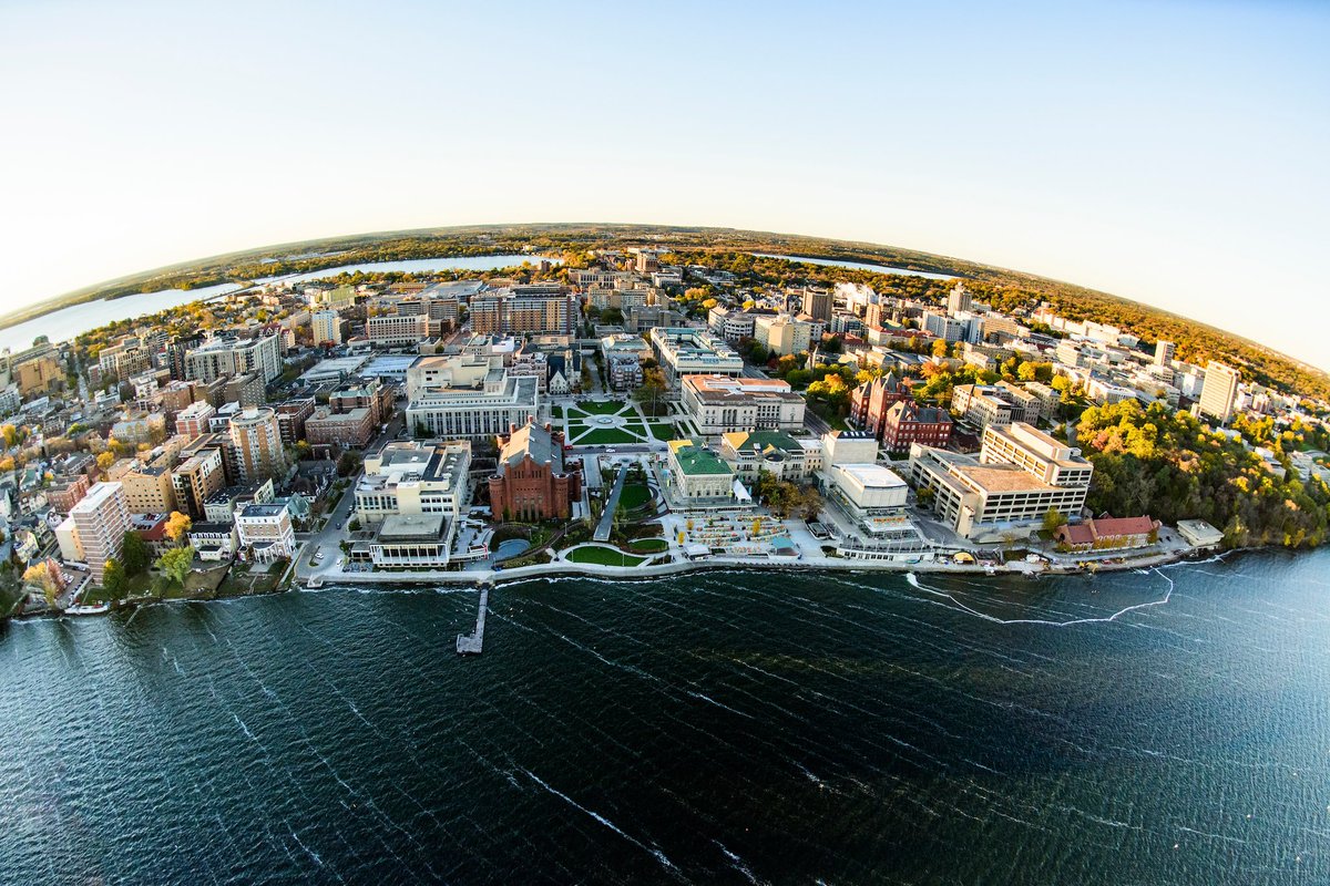 Aerial photograph of UW–Madison’s campus along the southern shore of Lake Mendota. Notable landmarks in the image include the Red Gym, Alumni Park and Library Mall, the Wisconsin Union Terrace, Science Hall, College Library, and Muir Woods.