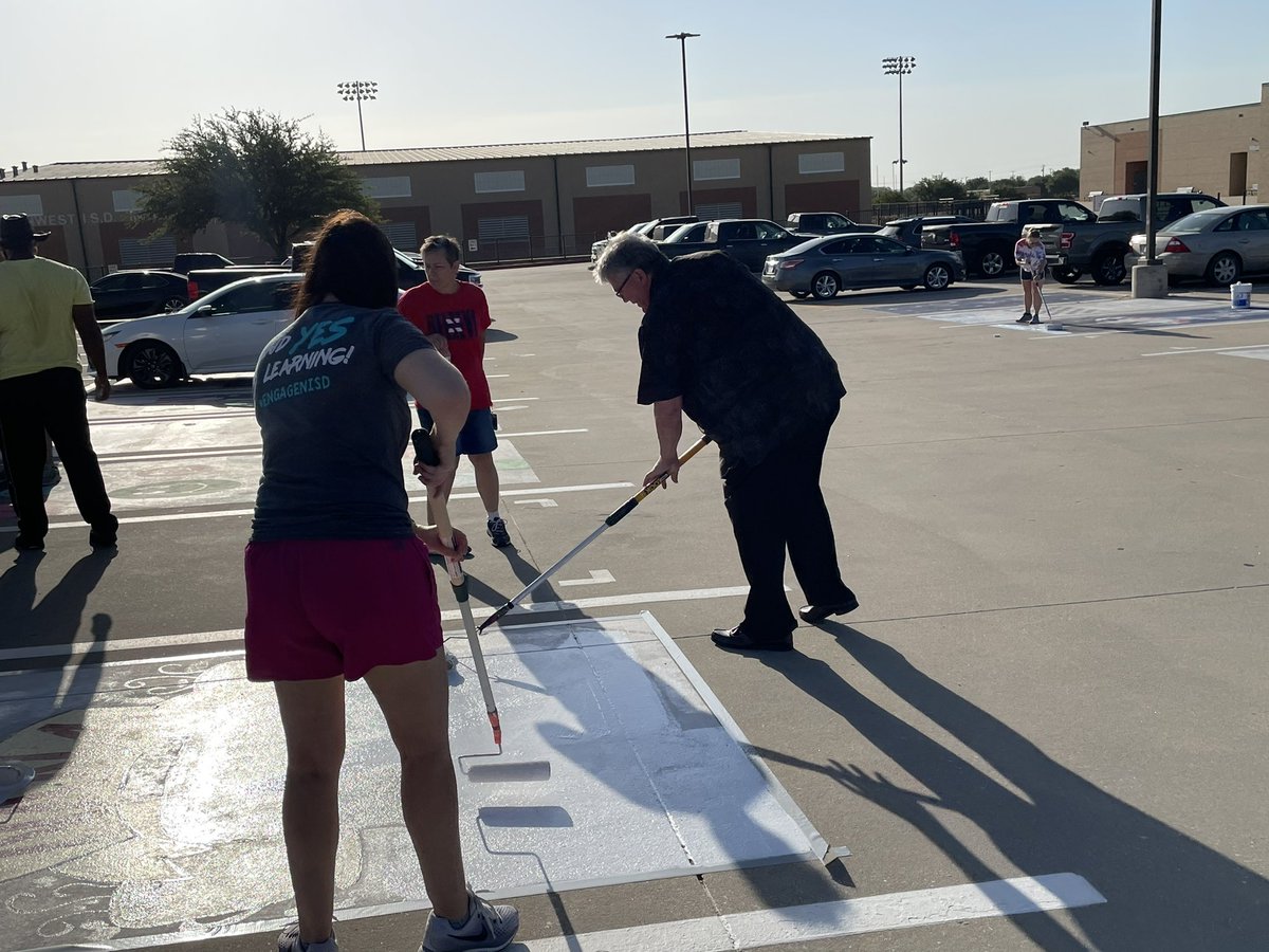 jackson_carrie's tweet photo. When you’re out early to paint over parking spots, and your @NorthwestISD Superintendent rolls up and says, “Hand me a roller; I want to help!” 🤠
#Flagship shirt for Dr. Hicks!!
@NHSTexans @NHSSeniors2023 #ServantLeader #MeaningMaker https://t.co/Aep7JGOJ9b