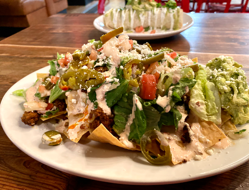 Don't feel guilty, you deserve all the toppings. The Rico Nachos are piled with queso, lettuce, pico, chipotle crema, pickled jalapenos, guac, cotija cheese and your choice of protein.