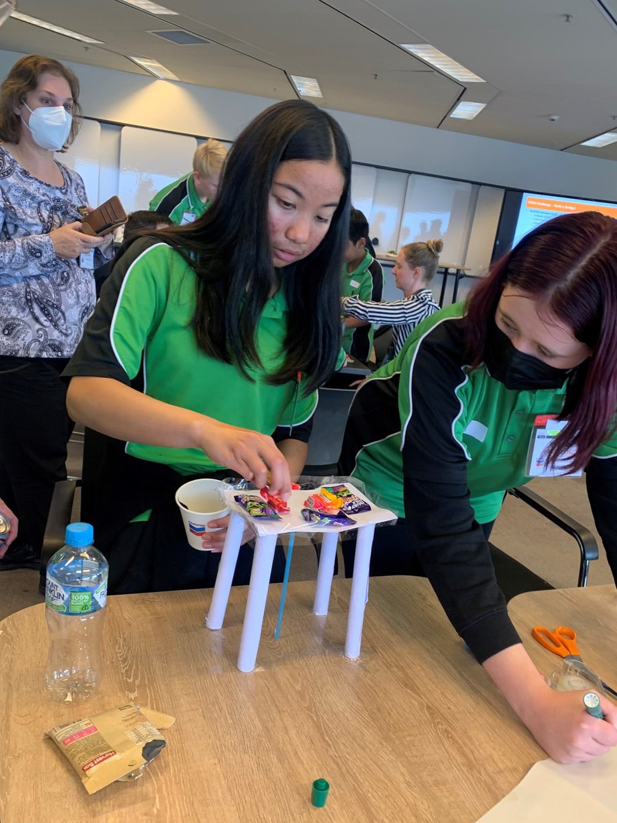 ABCNoz's tweet photo. Students from Swan View SHS got a little creative making bridges at their #ABCN Innovate session with @Chevron.

With some creative bending of the rules and mentor assistance, one group was able to balance 40 sweets, three packets of nuts, and a can of soft drink on their bridge. https://t.co/I6wWB3mbJB