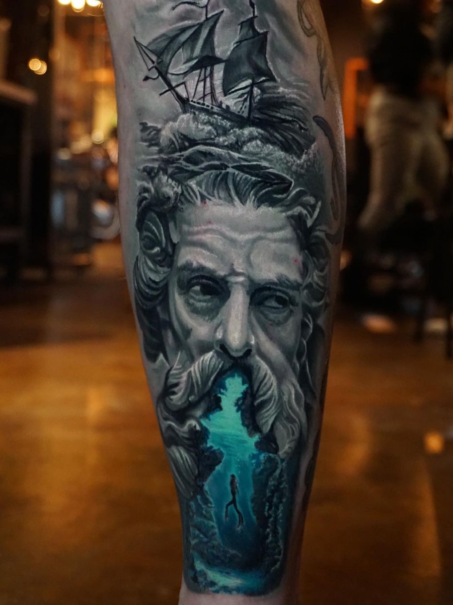 Black and grey style Poseidon tattoo on the left inner