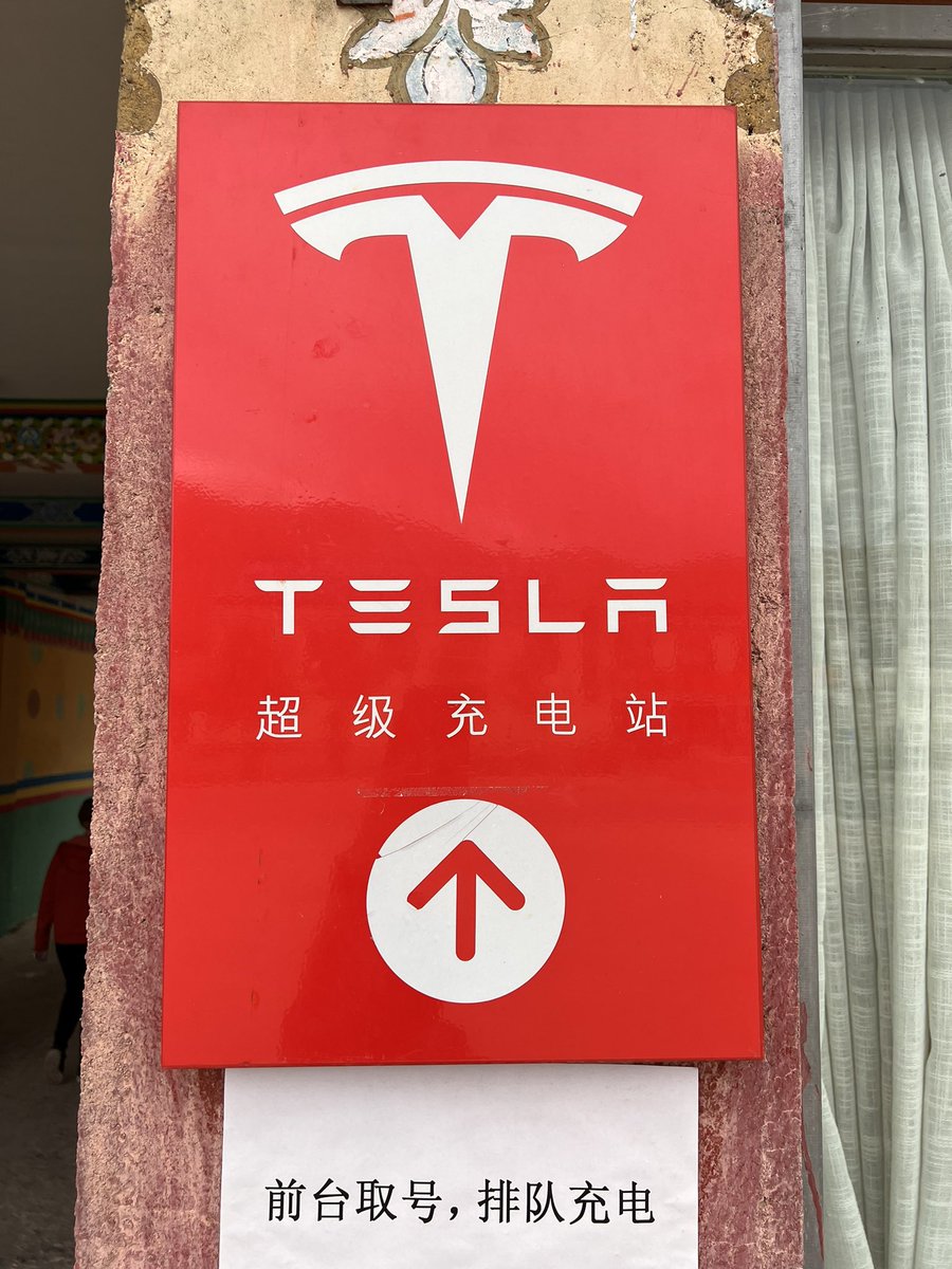 Umbango's tweet photo. At Mt Everest Nature Reserve in Tibet. Glad to see a Tesla charging point on the roof of the world! @elonmusk https://t.co/niBPUw2ac2
