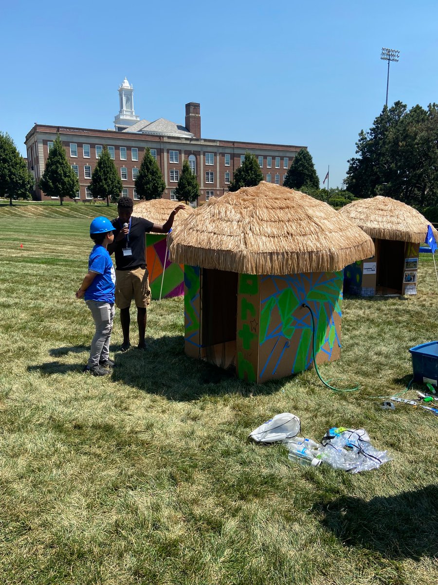 AquaAfrica's tweet photo. Executive Director, Buey Tut, interviews the captain of the @NStar360 (NorthStar) team about their hut construction. Northstar's competitors were the only team to successfully install running water inside their hut, from the solar-powered water tower. #BuildaHut @UNOmaha https://t.co/AVLATUiVMD