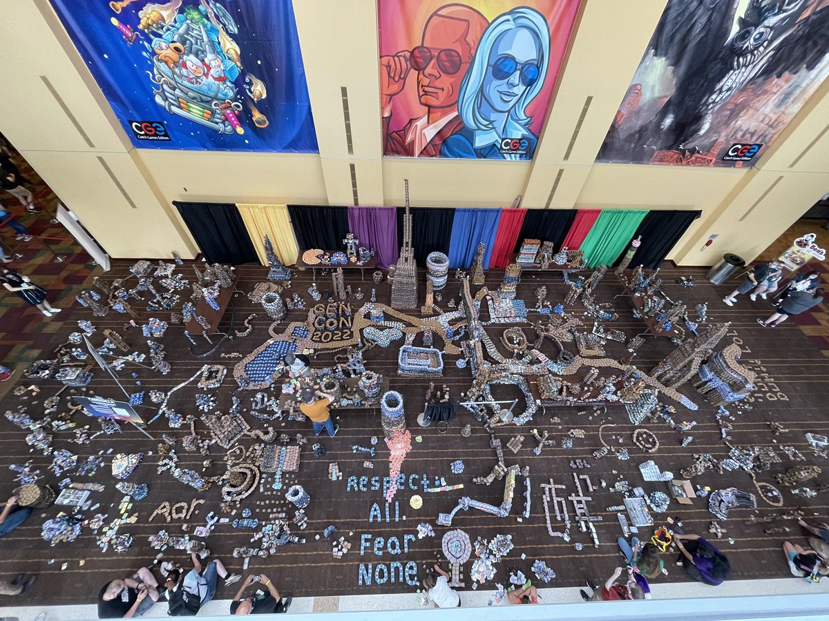 role_dice's tweet photo. #cardhalla is building up nicely! At the end of the convention people throw money at the towers to try knocking things down. All money raised is donated to the Patachou Foundation. #GenCon2022 https://t.co/xxfdYwcVXc