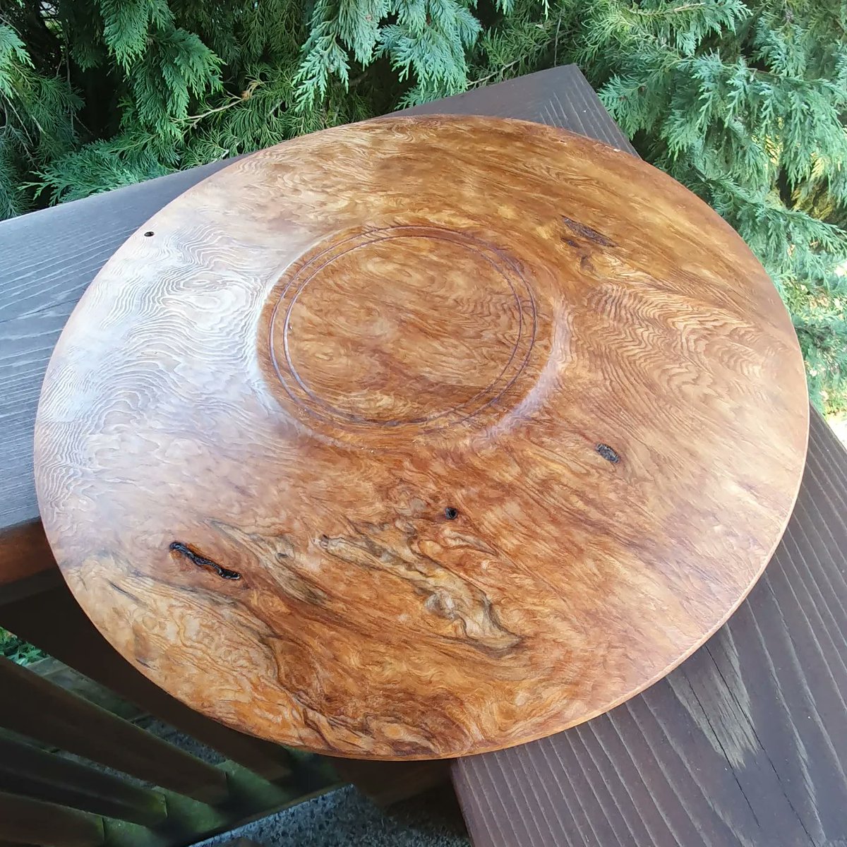 Cedar burl plate, about 12 inches in diameter.  It's from an old weathered burl cap that was lying under my workbench for ages and I finally decided to put it on the lathe.  The thickness did not allow me to do much but the wood is so beautiful that simple is better anyway.