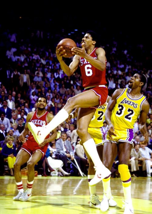 Magic watches Dr. J go up for a dunk during the 1983 NBA Finals