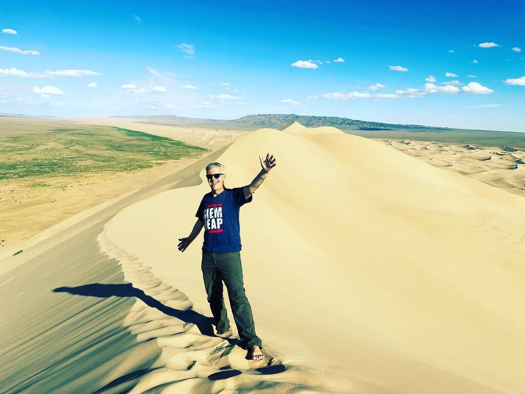 Khongoryn Els sand dunes.  about 400 metres / 1,300 feet high.  took over 1 hour to climb but only 1.5 minutes to get down. (fucker)  and in the 2nd pic, i’m pointing to 2 tiny black specks that are 2 human friends sitting and waiting.  that’s how far an… instagr.am/p/Cg7bGjzs0bc/