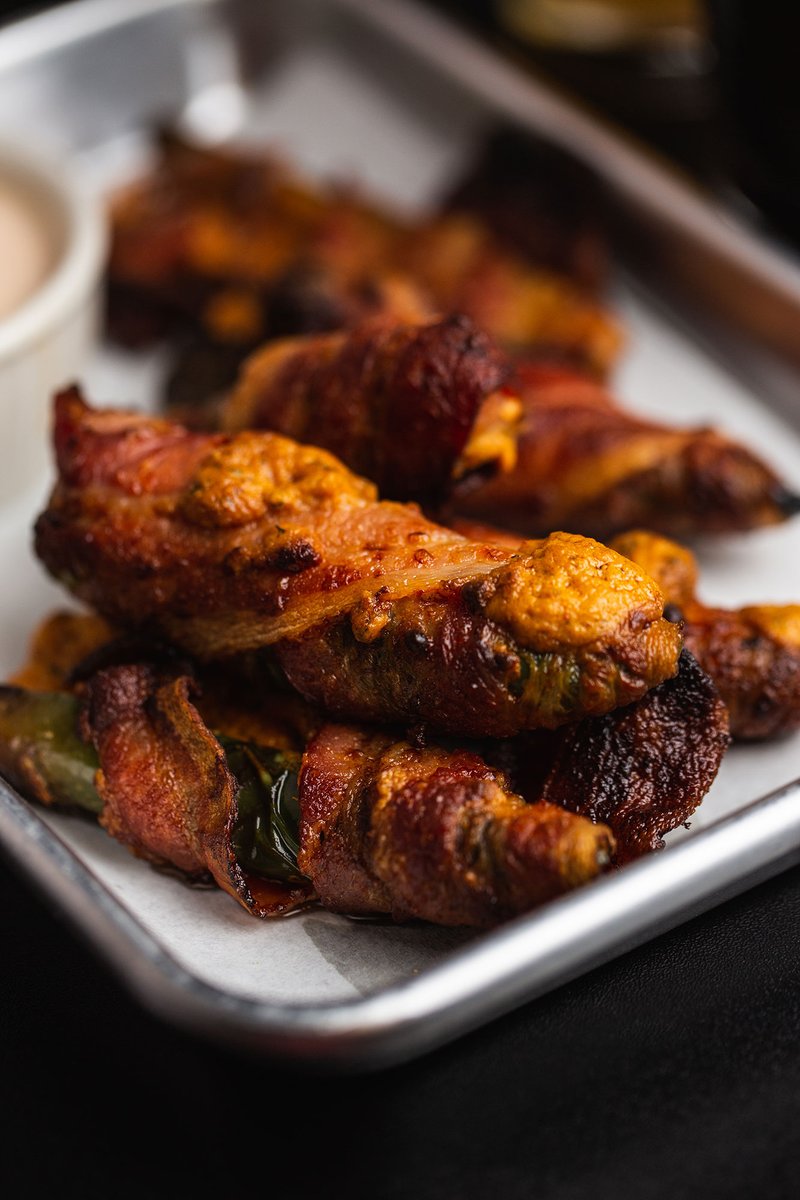 Bacon Wrapped Jalapeno Poppers. Jalapenos stuffed with a cheddar jack &amp; cream cheese filling wrapped in crispy bacon