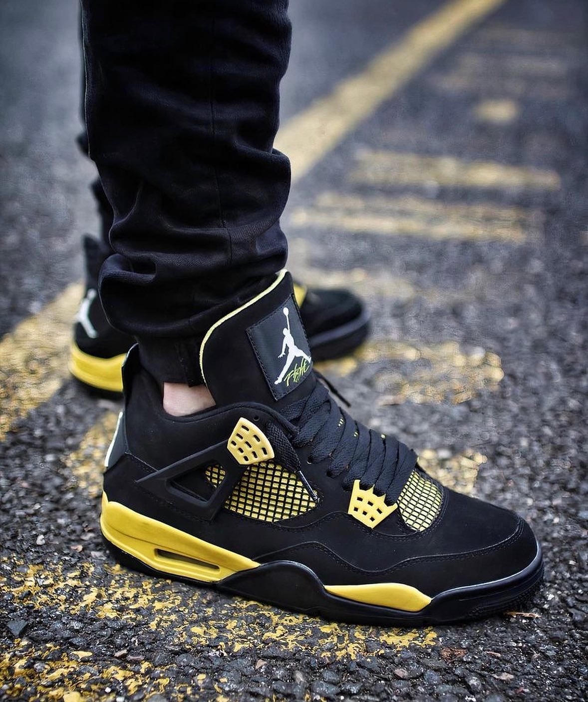 black and yellow jordan 4