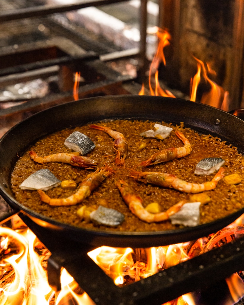 You can smell it before you see it. That unmistakable aroma simmering in a giant pan over an open flame, the intense heat of the fire dancing across the surface of the bubbling rice. 

This is the best paella served in the UK. Have you booked your table yet?