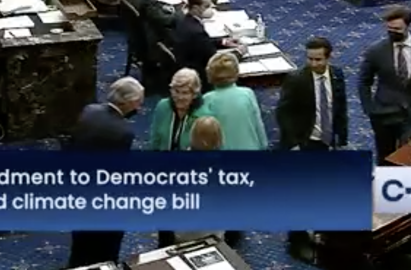 Warren is wearing a black hoodie under her blazer. Quite the lewk