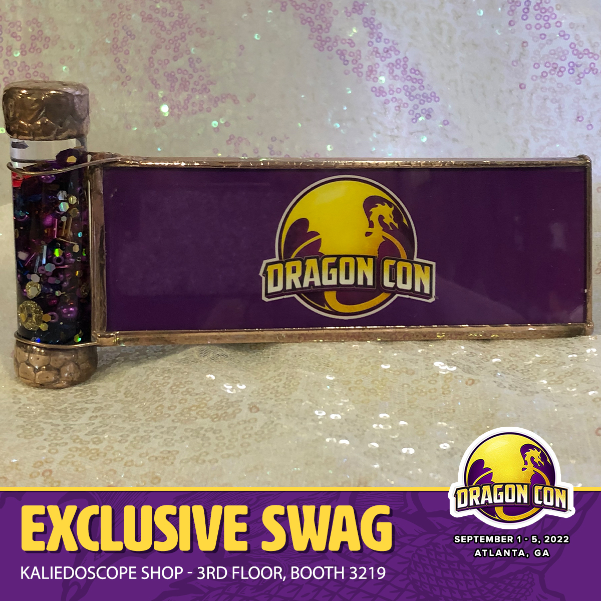 The must have item for #DragonCon2022: A handmade, limited edition kaleidoscope  that has the official DragonCon logo on one side and a brass dragon on the other! #SwagSunday Available from The Kaleidoscope Shop, 3rd floor, booth 3219.