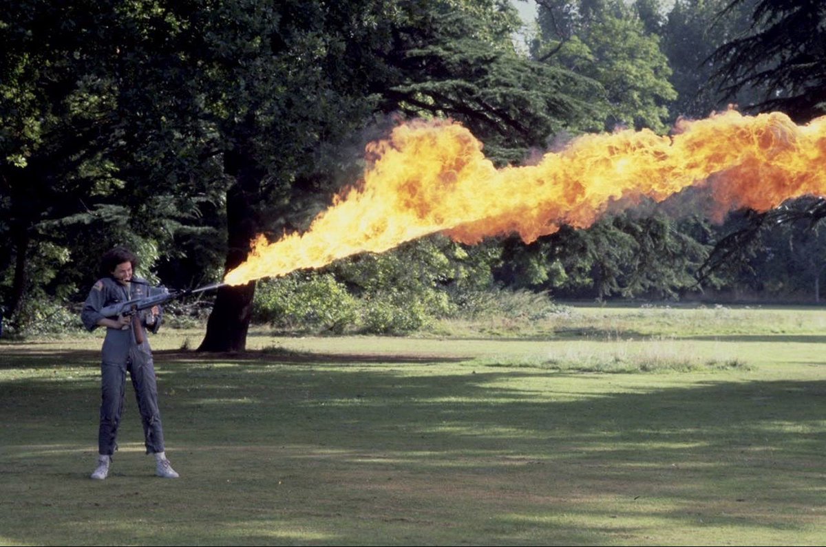Sigourney Weaver testing a flamethrower during the production of ALIEN.