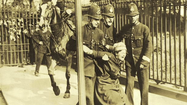 revmahoney's tweet photo. "They climbed statues, chained themselves to fences and burned “watch fires” in front of the White House."--Suffragists getting arrested in front of the White House. #OnWithTheRevolution #WeWillNotBeSilenced #CloudOfWitnesses #TestifySister https://t.co/chf4kdxHXR