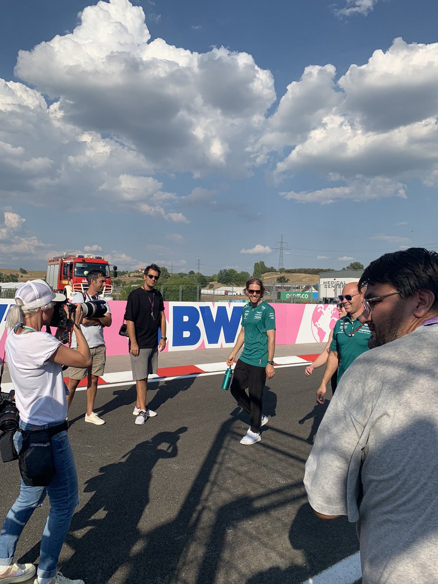 sevinalikesf1's tweet photo. THURSDAY: Team track interviews. Seb Vettel perched precariously on the side of the railings as he’s interviewed hours after his retirement announcement. @LewisHamilton looking incredibly fly and @GeorgeRussell63 with the sick skinny jeans. Mick and Kevin in full uniform. https://t.co/94rrtWUddZ