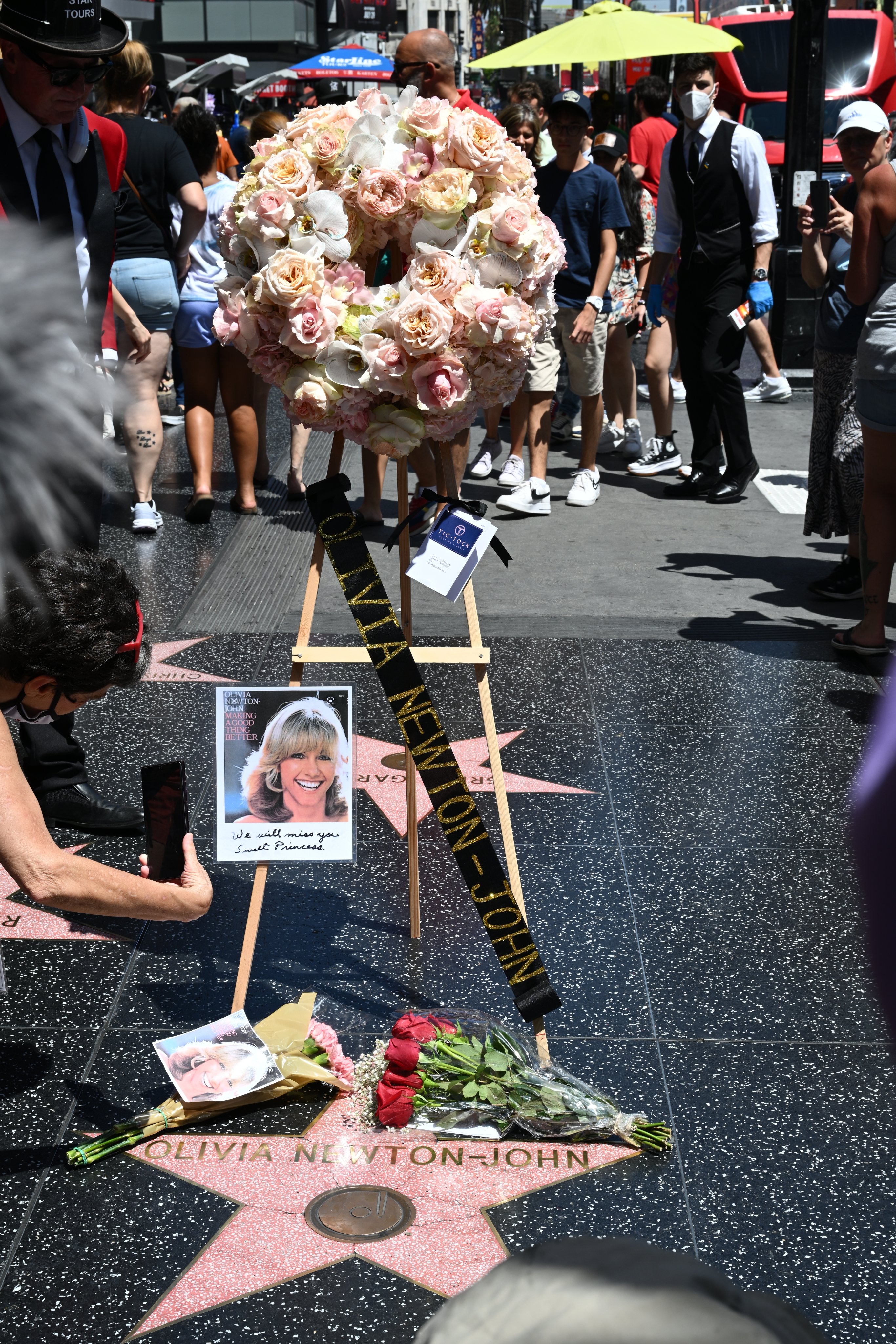 Flowers and photos of Olivia Newton-John on her Walk of Fame star.