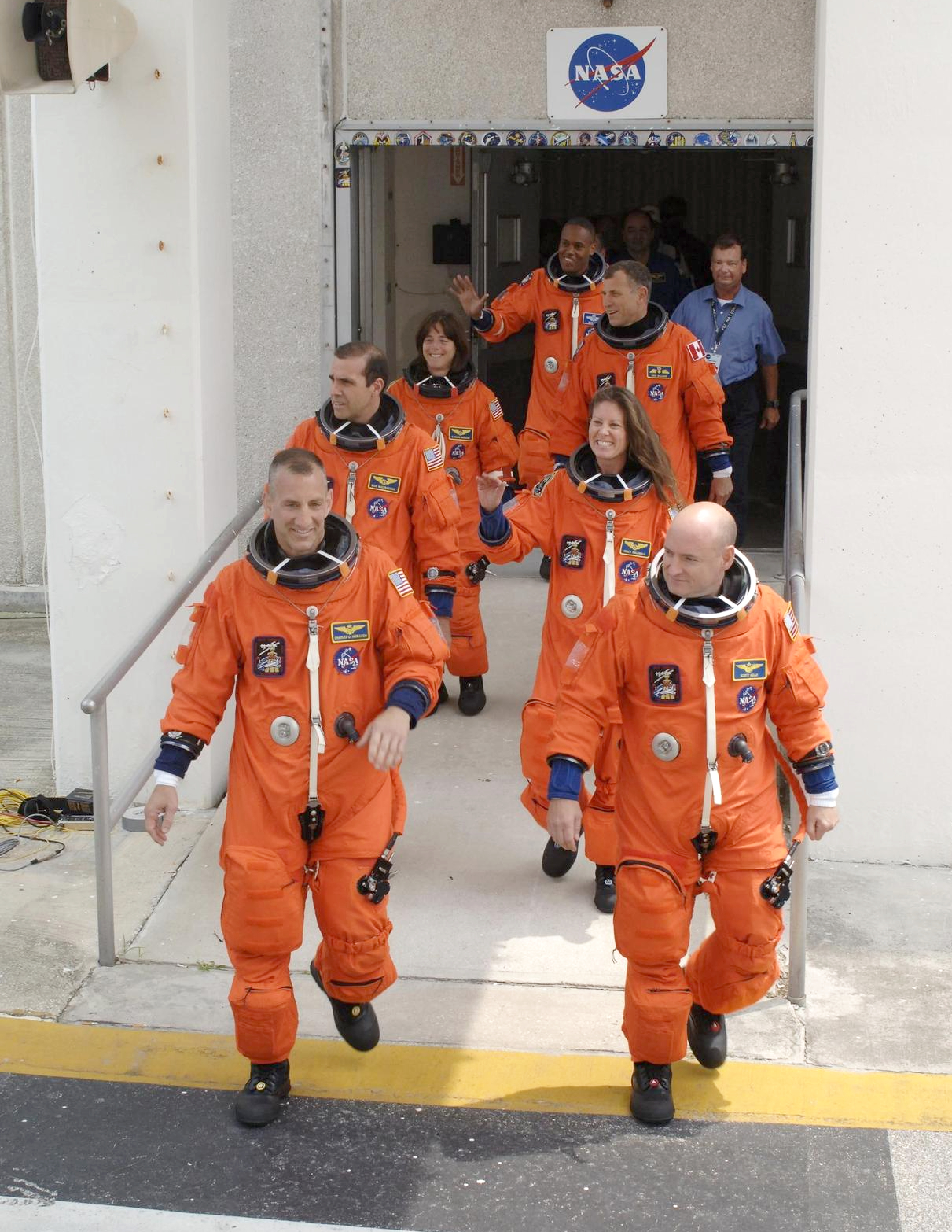 The STS-118 crew strode out of the Operations and Checkout Building eager to get to Launch Pad 39A for launch of Space Shuttle Endeavour at 6:36 p.m. EDT. Leading the way are (left and right) Pilot Charlie Hobaugh and Commander Scott Kelly. Behind them, clockwise, are Mission Specialists Rick Mastracchio, teacher-turned-astronaut Barbara Morgan, Alvin Drew, Dave Williams and Tracy Caldwell. Williams represents the Canadian Space Agency. The STS-118 mission was the 22nd shuttle flight to the International Space Station. Photo credit: NASA/Kim Shiflett