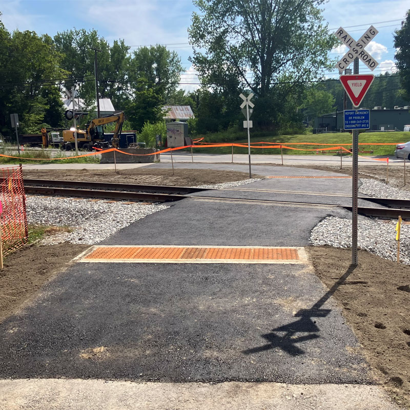 Montpelier Bike Path is open again, where the railroad work is happening at east side of City, near Route 2 and Route 302 roundabout. RR work is ongoing, but path is open. And with neat small sized RR Xing signs.