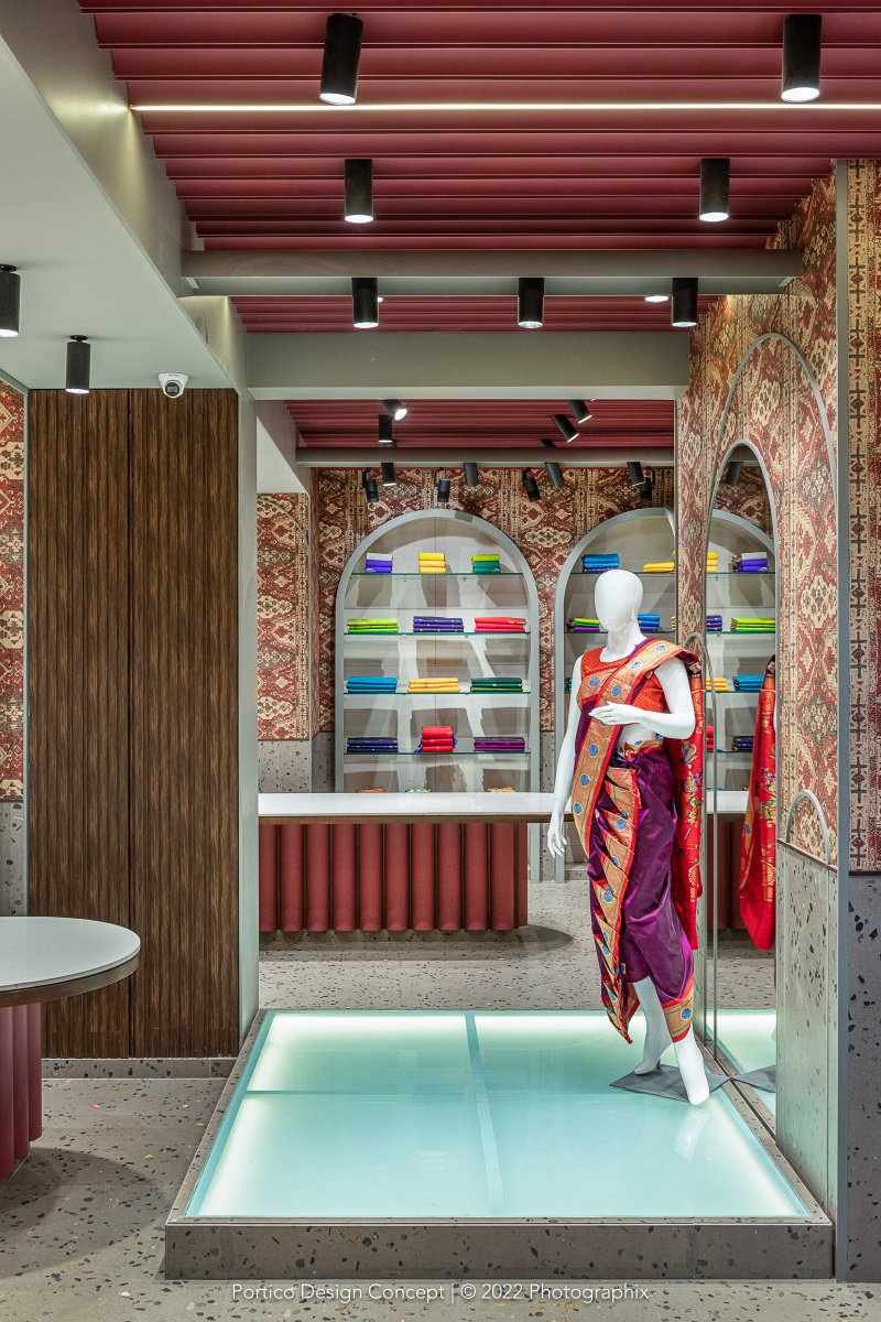 At Rangoli, sartorial creations get displayed in beautiful settings — against striking wallpaper, warm wood grains, in display shelves that form graceful arches, on illuminated glass elevations… #interiordesign #porticodesignconcepts #porticointeriors #storedesign