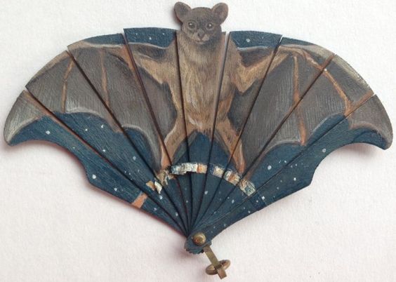 Hand painted, exceptionally rare miniature bat fan. On thin shaved wood. Circa 1900..