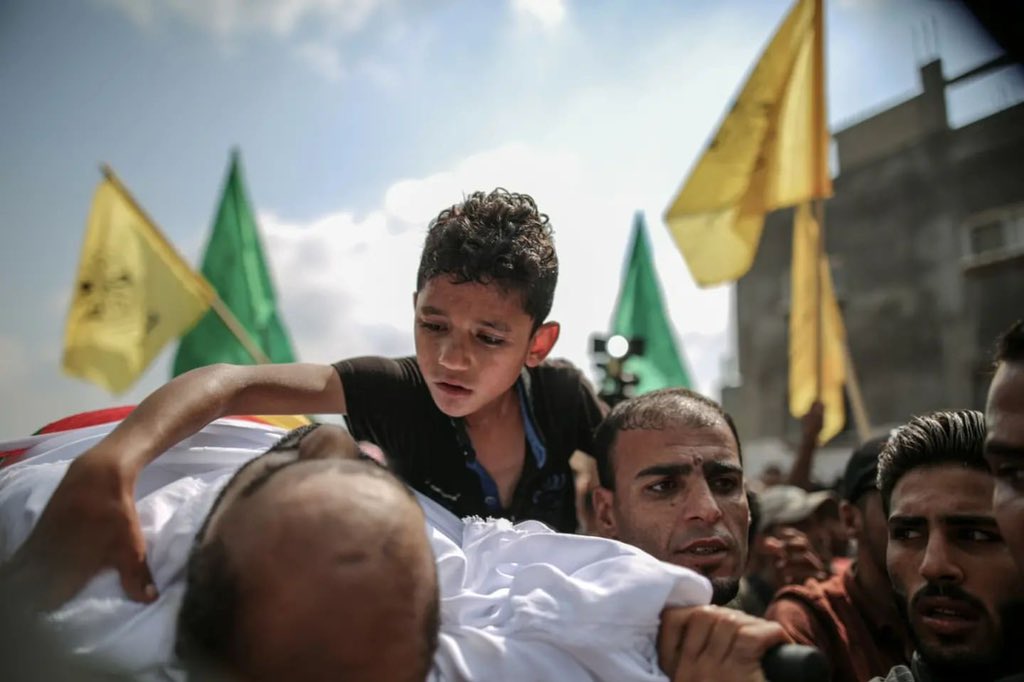 MuhammadSmiry's tweet photo. A Palestinian kid from Gaza during his father's funeral. https://t.co/162Ile3UQZ