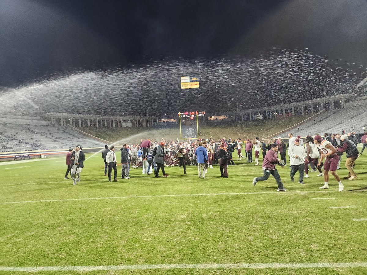 The scene as the #Hokies take a photo with the Commonwealth Cup and the sprinklers came on here in Charlottesville