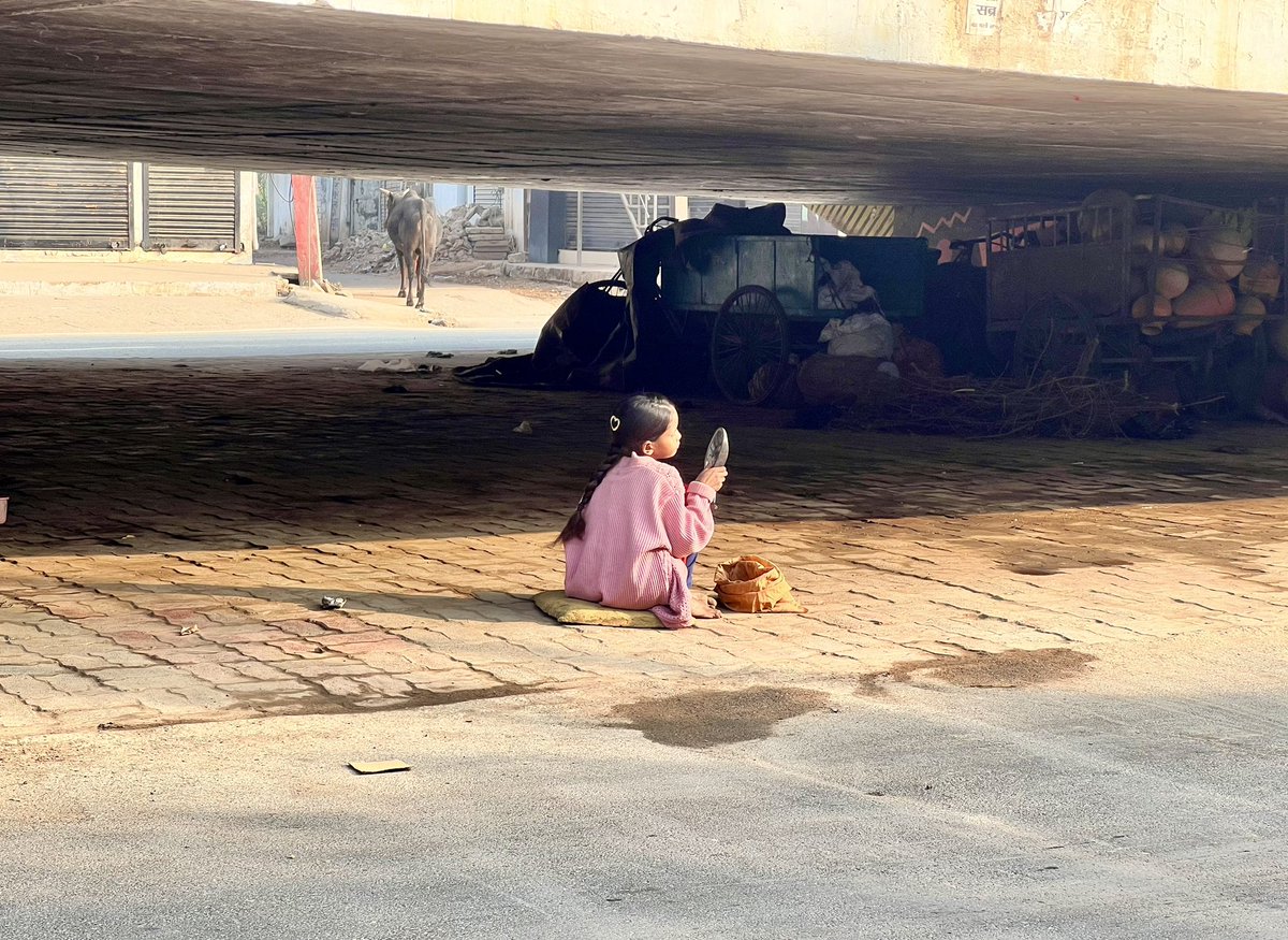 Being happy needs no resources & money. Saw this cute little girl during today’s morning walk ,sitting below a flyover & using a motorbike mirror to make her up and get ready. She really was enjoying her own beauty and looks….Can we be a fraction of satisfied and happy as she is