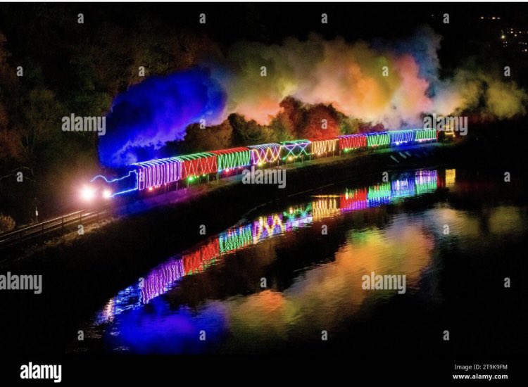 GrahamHuntPhoto's tweet photo. The Christmas Train of Lights on the Dartmouth Steam Railway is reflected in the River Dart as it leaves Kingswear in Devon yesterday evening.  My full set of images available on @Alamy_Editorial - @DartmouthRR #Devon #Christmas2023 #news #photojournalism #Railways https://t.co/tj4RWZCV07