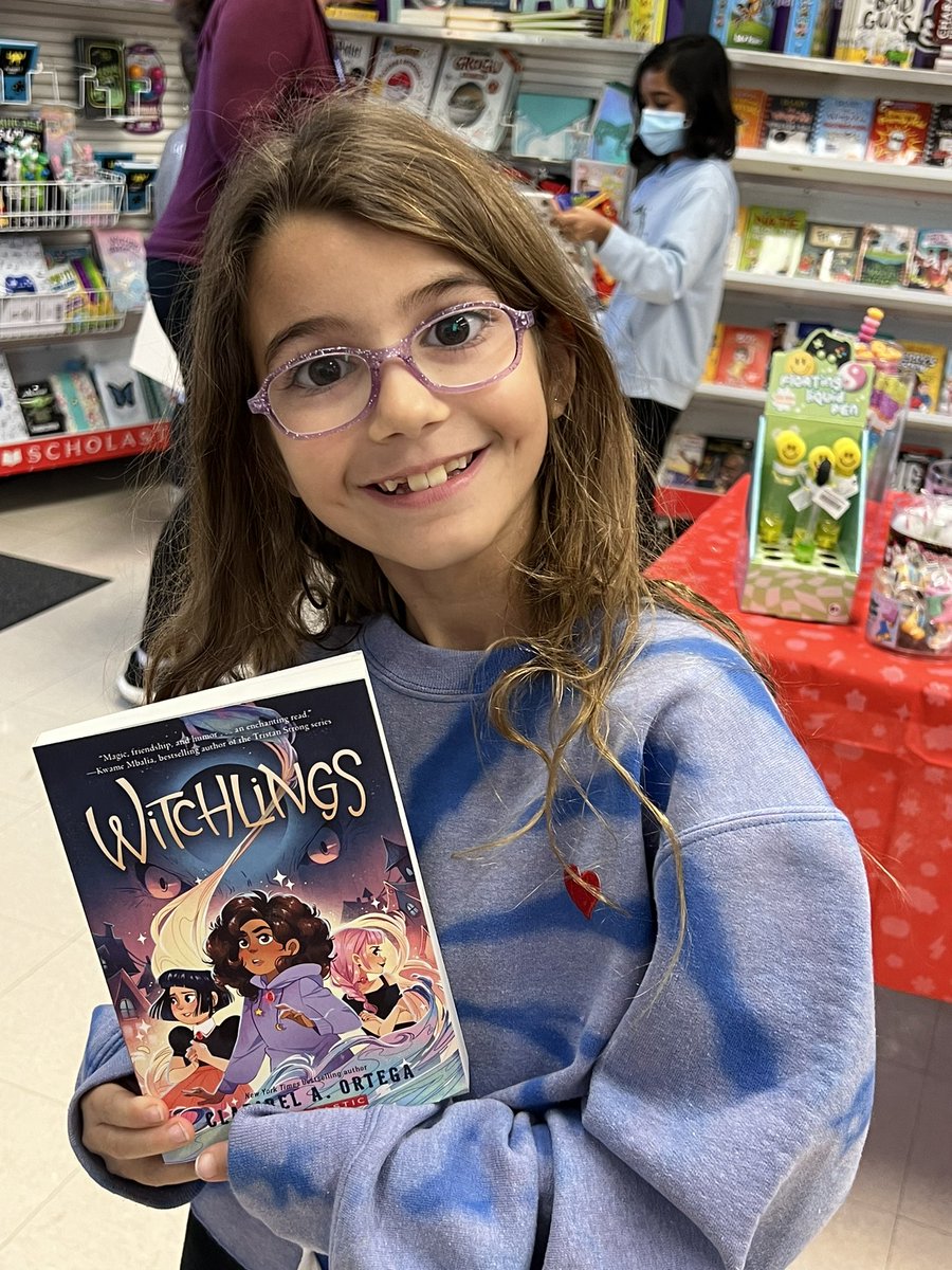 SportsGalNYC's tweet photo. When your daughter finds a book/author that you’ve interviewed and insists on getting the book at the @Scholastic book fair. Look @Claribel_Ortega, a new fan! She’s ready for book 2! https://t.co/hCNReNFtLz