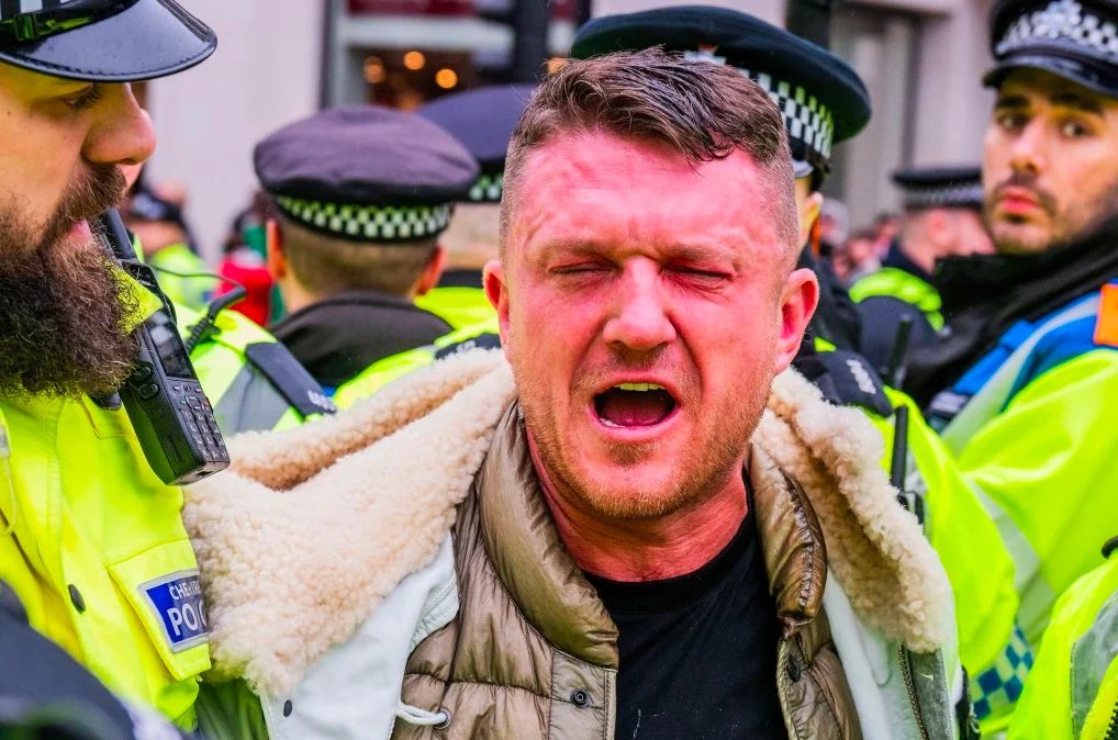 Tommy Robinson is led away by police today shortly after being sprayed in the face with pepper spray