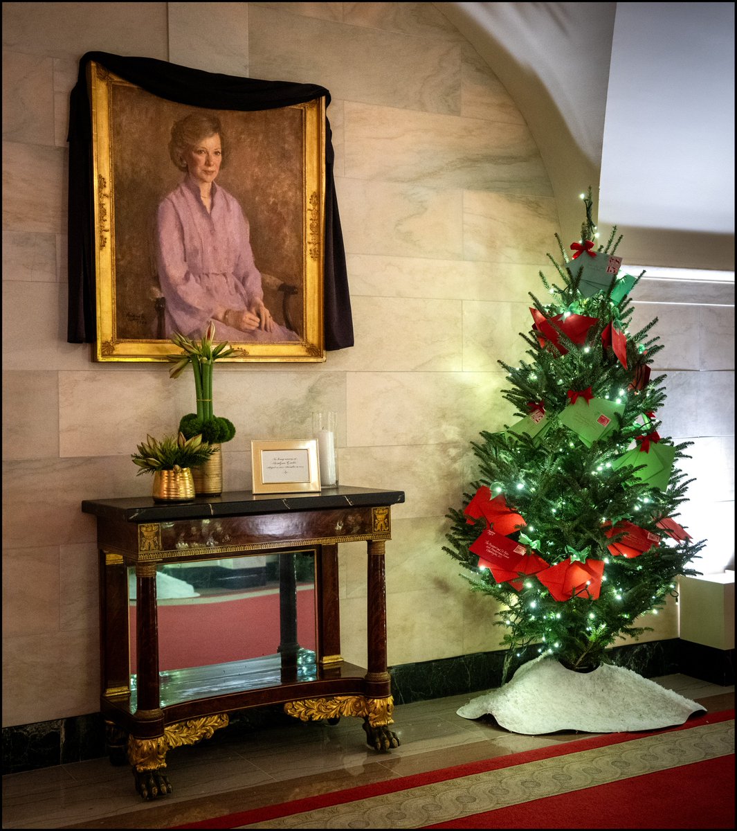 A portrait of Former First Lady Rosalynn Carter is draped with a black cloth at The White House.