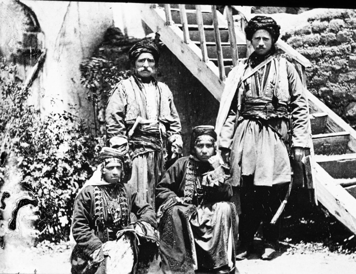 Kurdish men and women in traditional clothes, Caucasus, 1898. The clothing of men and women are quite beautiful and eye-catching. Archive of Archaeologist Baron J. de Baye (1853-1931)