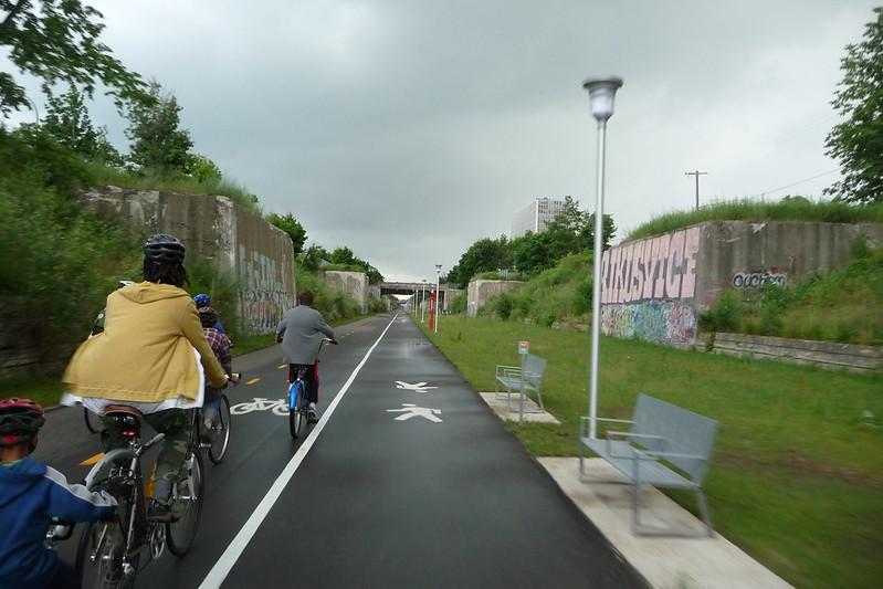 Detroitisit's tweet photo. Have you been to the Dequindre Cut lately? 

Opened in May 2009, this 2-mile greenway, once the Grand Trunk Railroad line, is a vibrant urban path for bikers, joggers, and art enthusiasts. 
 
Running below street level from Mack Avenue to Atwater Street, it's famous for its urban artwork and graffiti. The greenway features a wide pathway with separate lanes for pedestrians and cyclists.
 
📸: Rex Roof