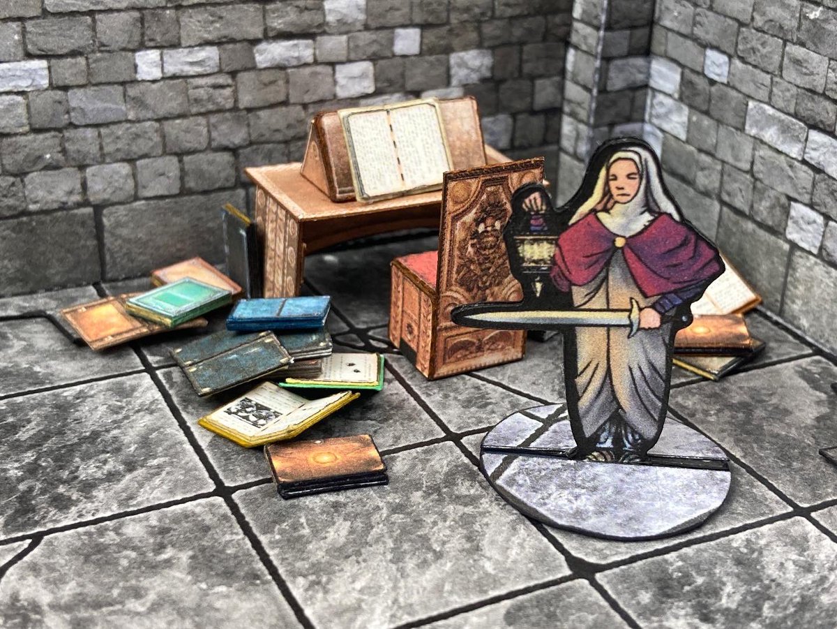 Some <a href="/BraveAdventure5/">Brave Adventures</a> minis in Paper Realms terrain for inspiration. While the Sisters of the Blue Moon ready for battle against some shapeshifting demons, Sister Ildrid explores a corner of the archives desperately looking for clues as to how to defeat their daunting foes!