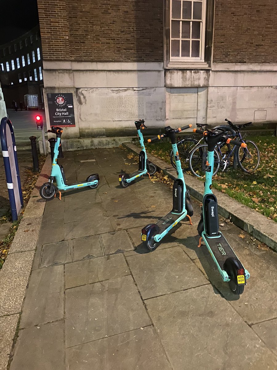 platformcontrol's tweet photo. @David_on_a_bike @BristolCouncil @tier_mobility @WestofEnglandCA This was the scene ironically outside the council building at 6pm last night, not one of these scooters was working and none available within 500m. Ended up calling wife to pick me up. Back to driving into work - so much for reducing cars coming into town. #uttershambles https://t.co/ctFzdFfqoX