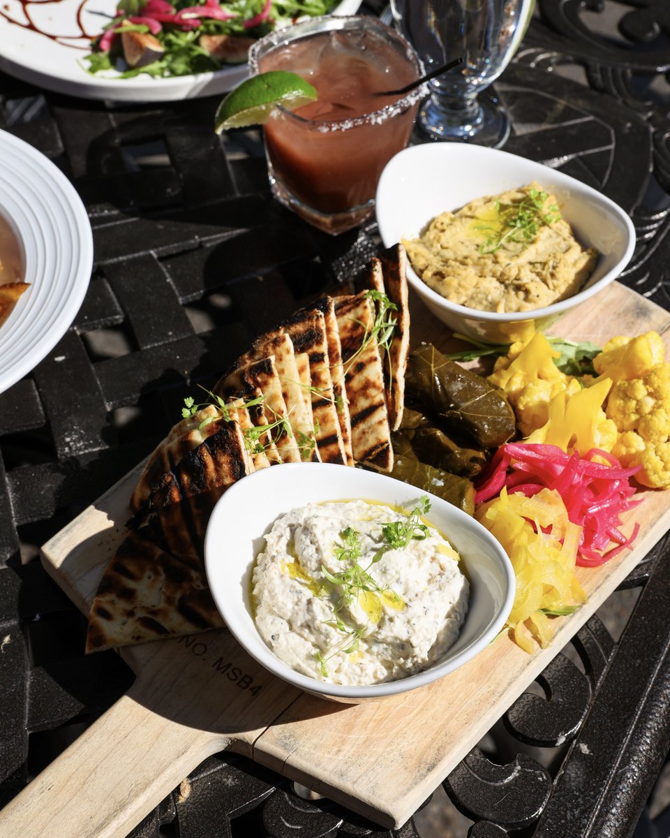 Dip into our Mediterranean Mez Board with hummus, whipped ricotta, grape leaves, marinated olives, warm pita, and a vibrant selection of pickled vegetables 🙌 😋