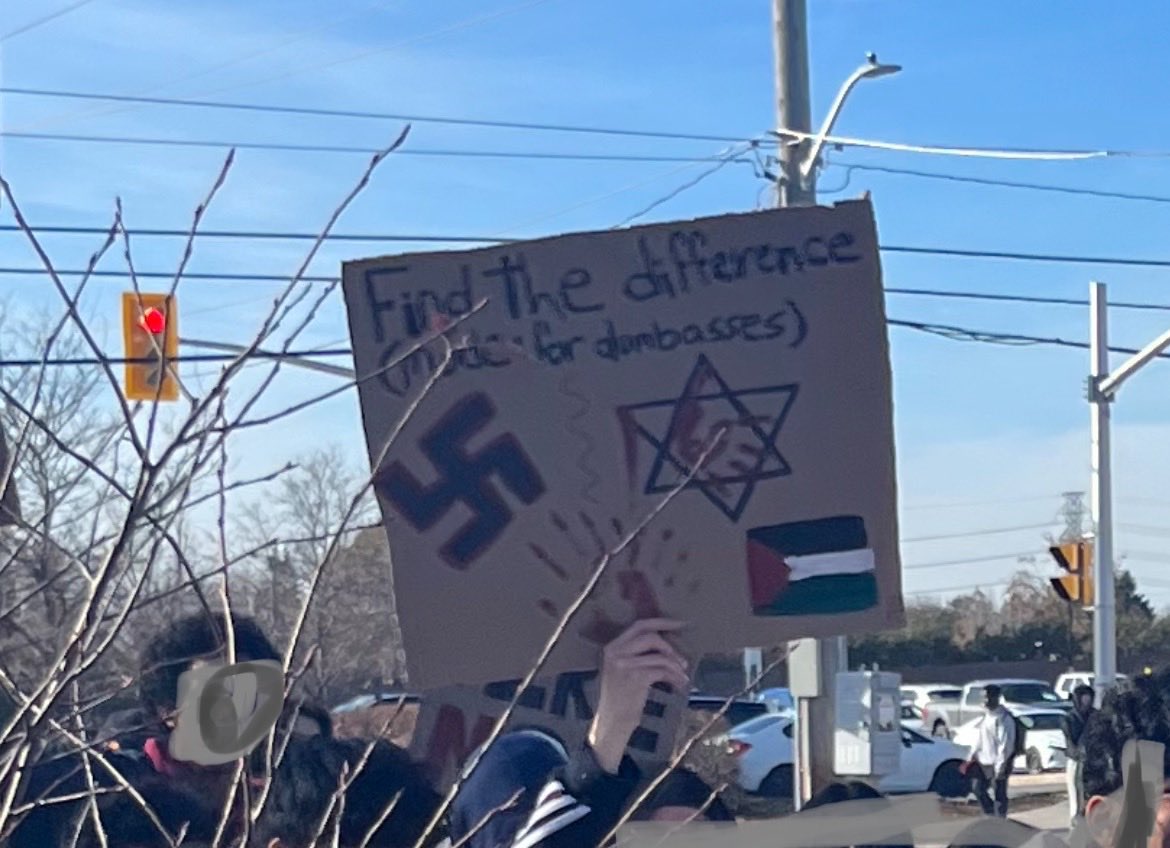 CIJAinfo's tweet photo. It’s NEVER ok to use a Nazi swastika.

Putting it alongside a Star of David &amp; asking people to “spot the difference” is a whole other level of antisemitic hatred. 

This was spotted at a *high school* “anti-#Israel” rally in the #Ottawa area earlier today. #Antisemitism #cdnpoli https://t.co/aWXYzbcmKz