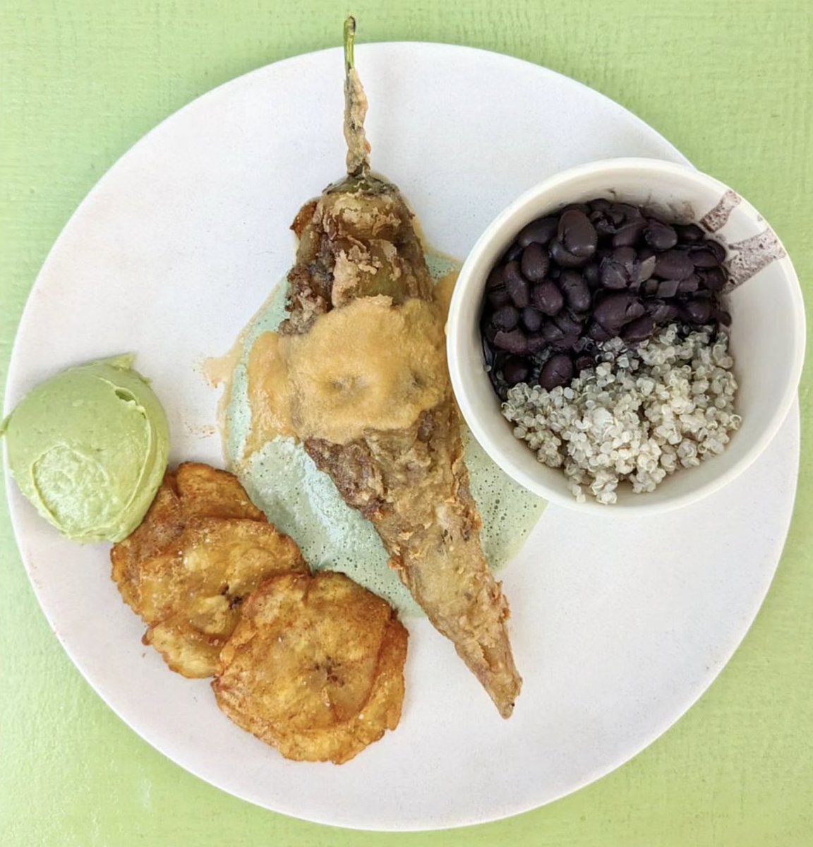 Felt cute.... made a special ( might delete later)

Chile xcatic stuffed with our house cazon and fried to perfection. Served over our epazote sauce and chiltomate. Our yucatecan beans and garlic onion quinoa complete the plate along with twice fried patacones and guacamole.