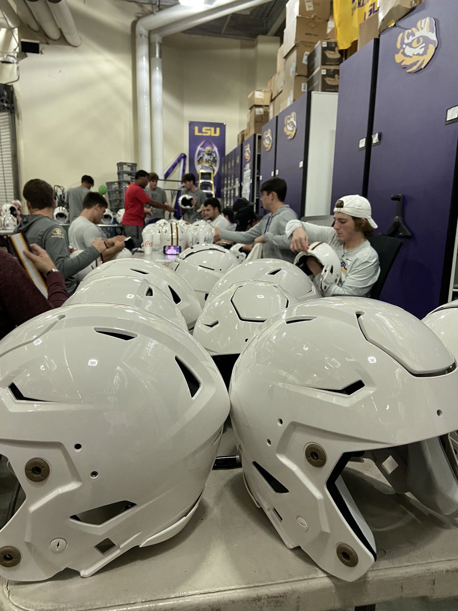 busy football helmets Busy night in the equipment room prepping the white helmets for this weekend