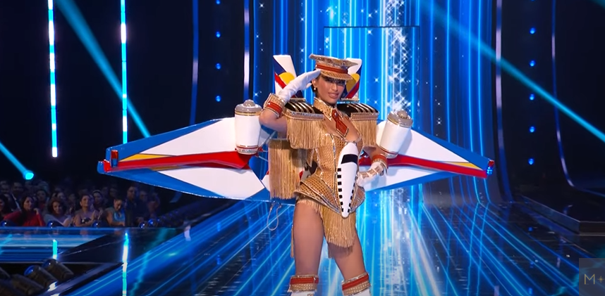 PhilstarNews's tweet photo. SALUTE TO SERGEANT MICHELLE MARQUEZ DEE 🫡✈️

Miss Universe Philippines Michelle Dee mesmerizes the universe as she struts across the #MissUniverse2023 stage for the national costume competition, wearing an outfit that represents a plane and a captain’s hat, showcasing the gems of the Philippines.

“Rising from her back, wings bear the colors of the Philippine flag and a mural of it’s most breathtaking sights while parading the country’s official tourism slogan: #LoveThePhilippines. Crowned with a captain’s hat, this is a salute to her role as an Air Force reservist and to our boundless adventures awaiting in the skies,” reads a post on Dee’s Instagram page.

📸 Miss Universe/Youtube, Michelle Dee | via John Marwin Elao