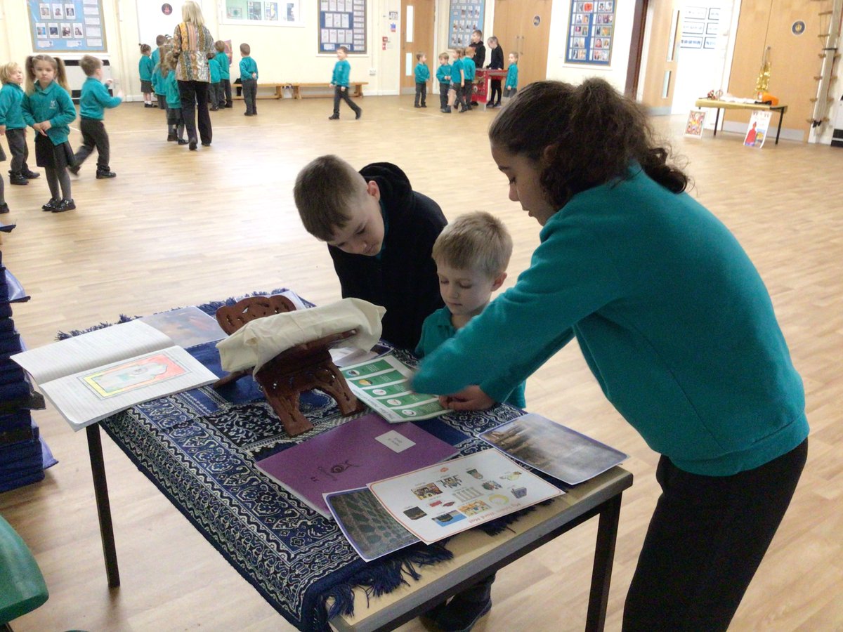 ClaveringSchool's tweet photo. To celebrate Interfaith Week, each class set-up a display table about a religion they have studied previously. The children throughout school visited the hall to see the displays that other year groups had created. https://t.co/uykPPJ6yMT